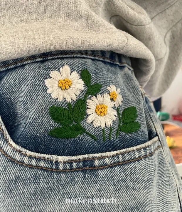 Daisy pocket embroidery pattern stitched on jeans
