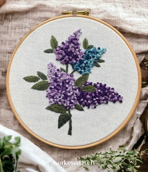 Lilac bouquet hand embroidery pattern featuring purple and blue flowers with green leaves