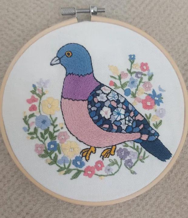 Customer embroidered pigeon surrounded by colorful flowers