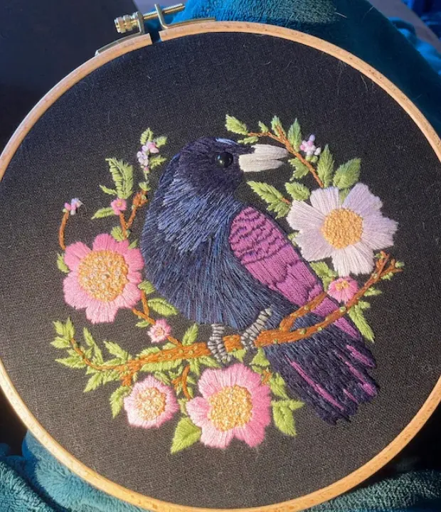 Customer embroidered raven with pink flowers on black fabric
