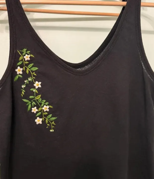 Customer embroidered floral branch on black tank top
