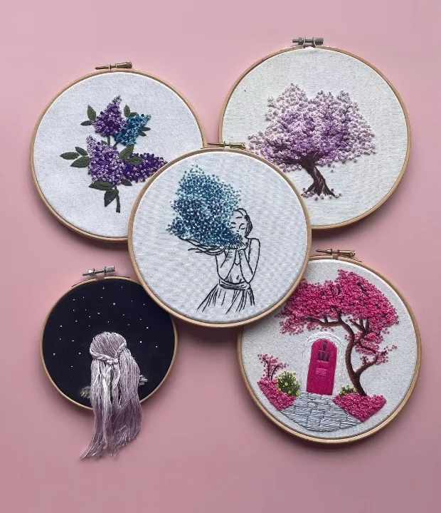 Hand embroidery pattern bundle featuring five colorful floral and whimsical designs in embroidery hoops